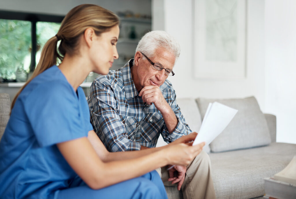 Healthcare professional discussing paperwork with patient