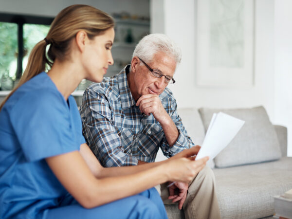 Healthcare professional discussing paperwork with patient