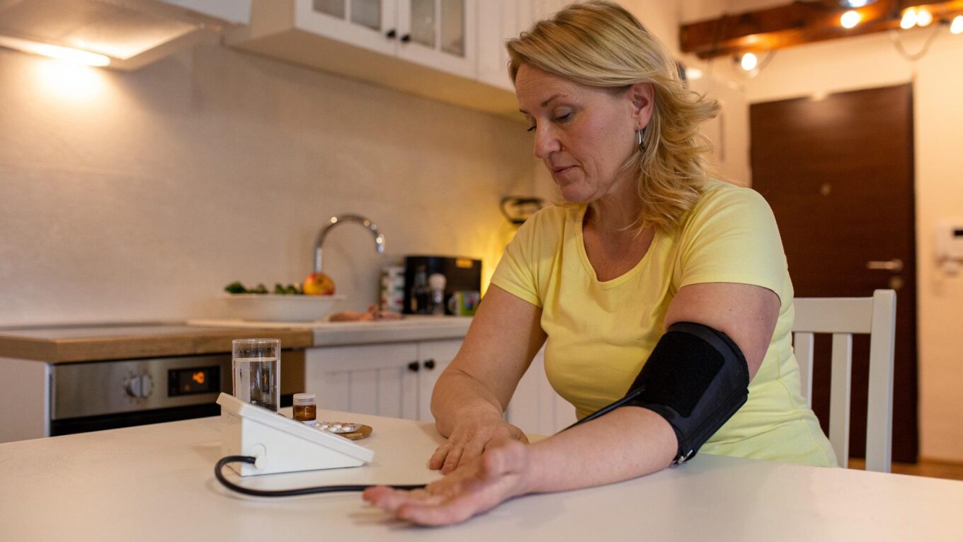 Woman measuring her blood pressure