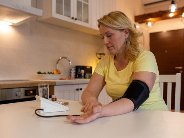 Woman measuring her blood pressure