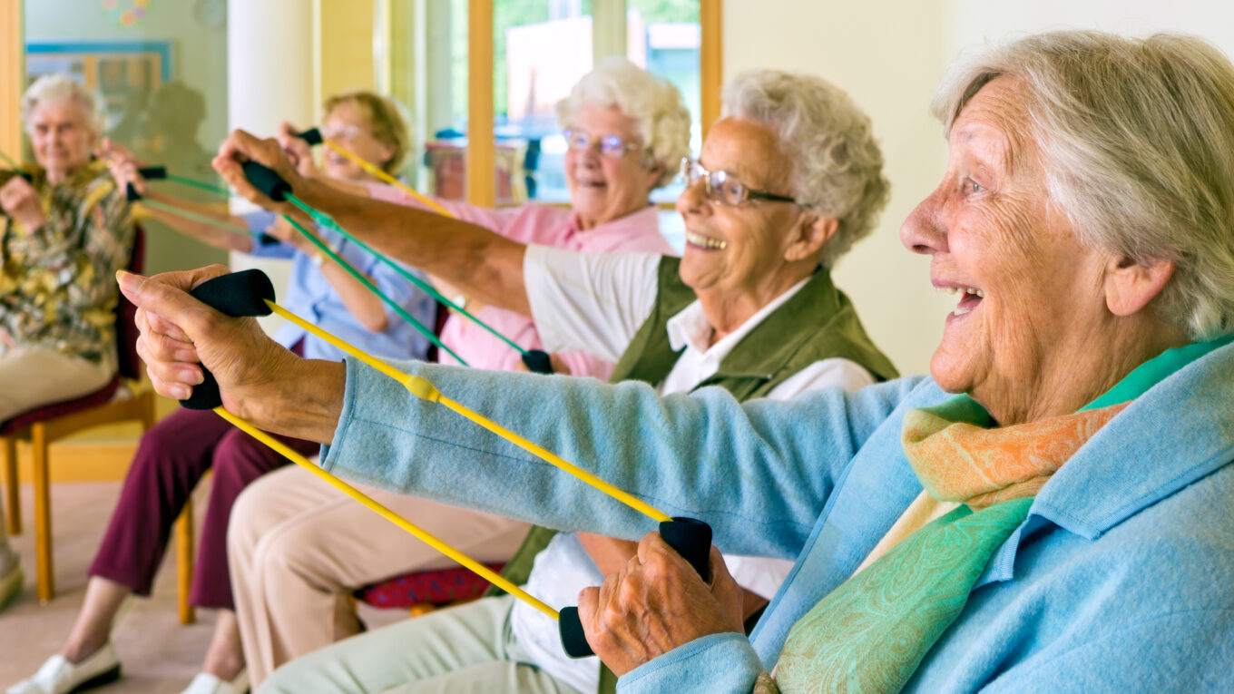 Elderly women doing resistance exercise to counteract sarcopenia