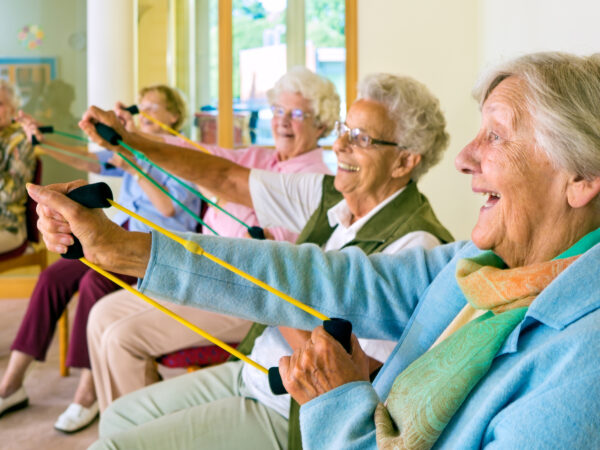 Elderly women doing resistance exercise to counteract sarcopenia