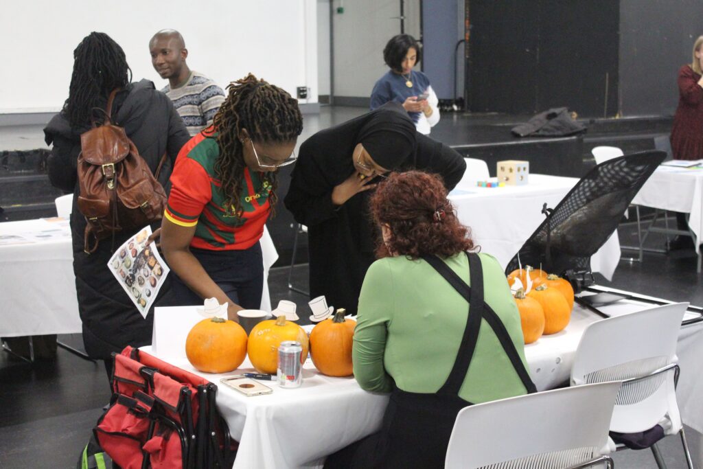 IMG_2111 Two young Black women looking at maternity stand at community event