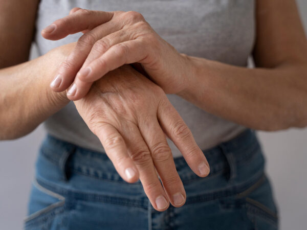 Middle aged woman holding her painful hand