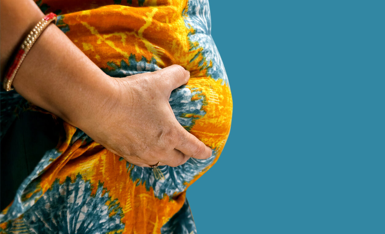 Woman pinching her abdomen