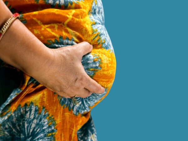 Woman pinching her abdomen