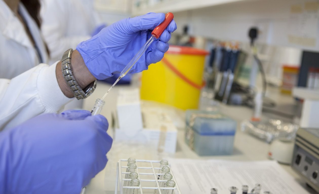 scientist using pipette in a lab