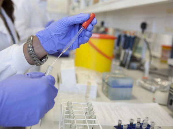 scientist using pipette in a lab