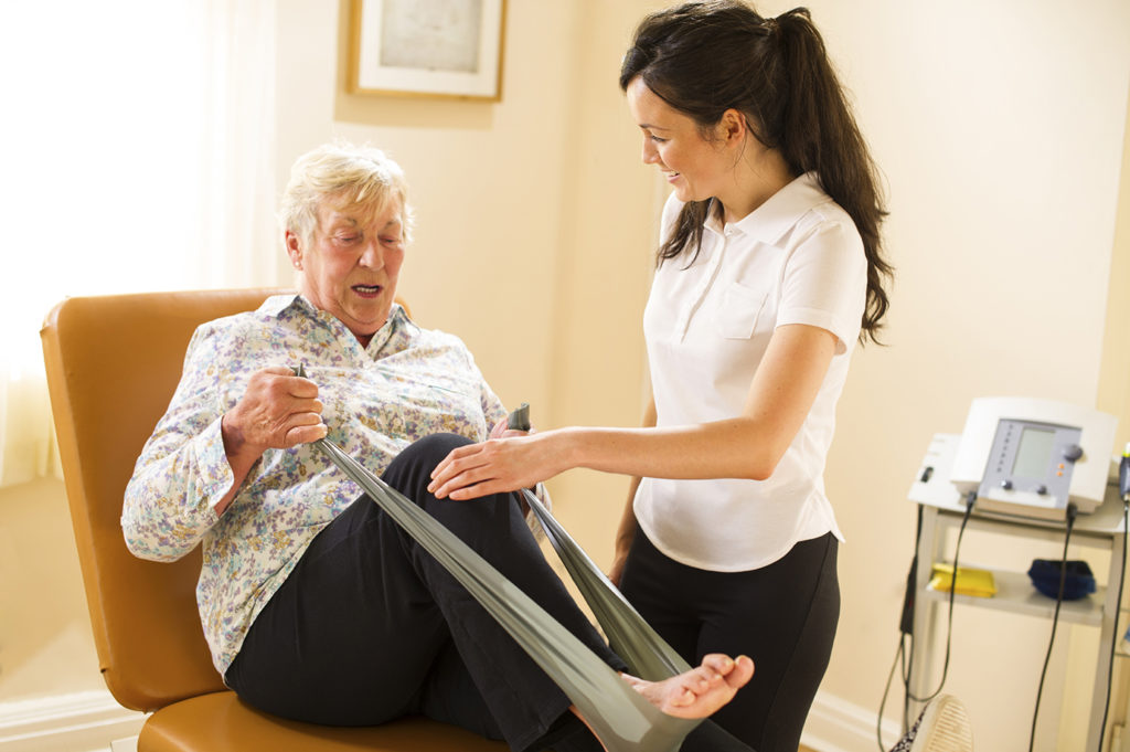 Healthcare assistant working with patient